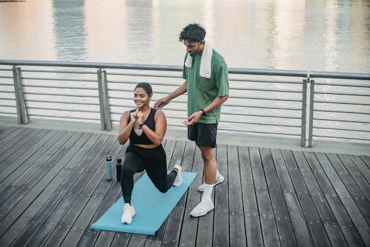 Man and woman exercising outdoors on a yoga mat by the water, promoting a healthy lifestyle.